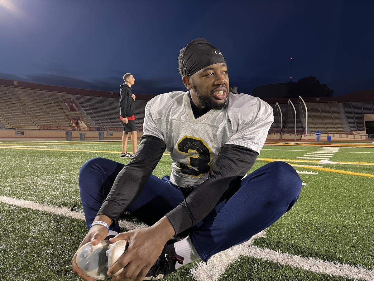 Terrence McDonald of the law “Hogs,” seen stretching Tuesday at Hughes Stadium, will play in his 10th Pig Bowl charity football game this Saturday at Sacramento’s Cal Expo.