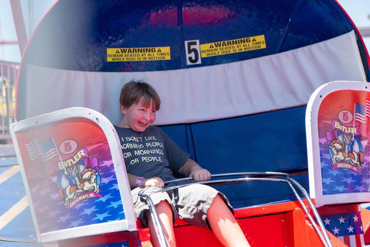Paxton Heafner, 11, laughs while riding the Tilt-A-Whirl at the California State Fair on Tuesday. Heafner said the ride was “fast and exciting.”