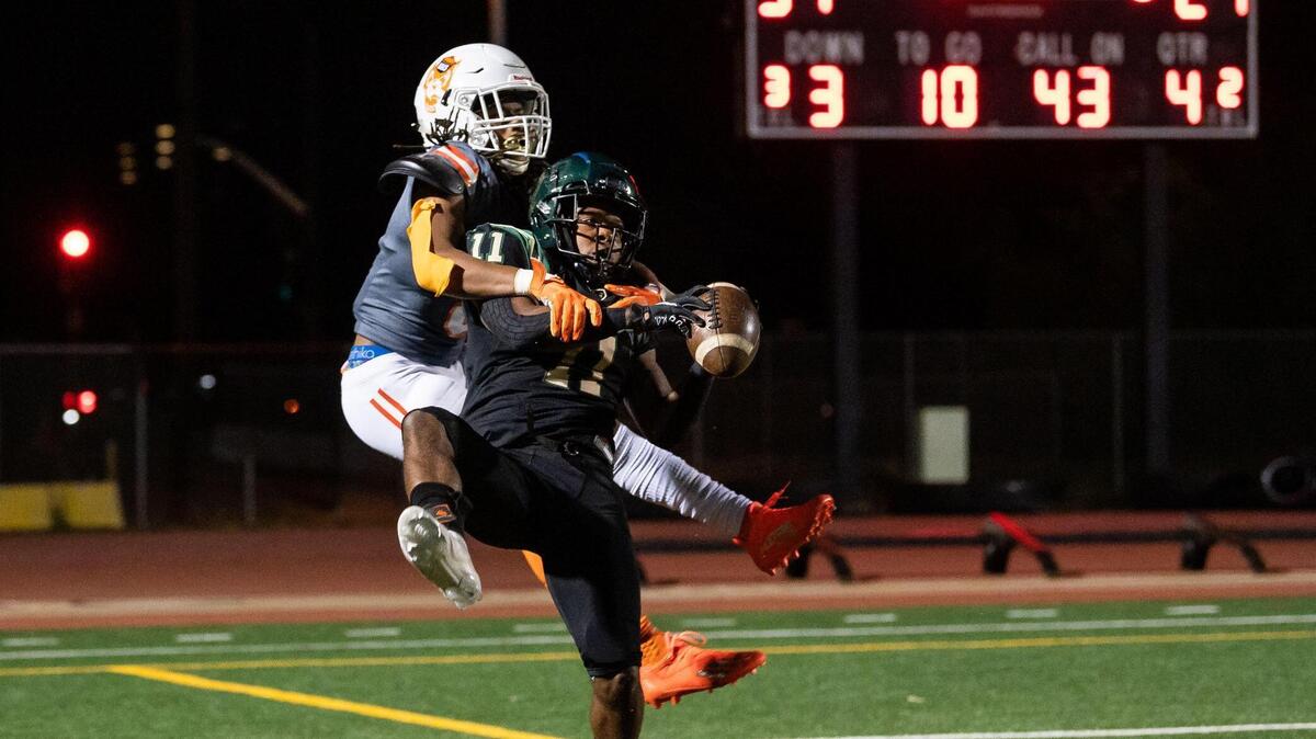 Monterey Trail’s Jamauri Jackson, right, intercepts a pass intended for Cosumnes Oaks’ Gregory Bradley during the fourth quarter of the high school football game Friday, April 2, 2021, at Monterey Trail High School in Elk Grove. Monterey Trail beat Cosumnes Oaks 57-21.