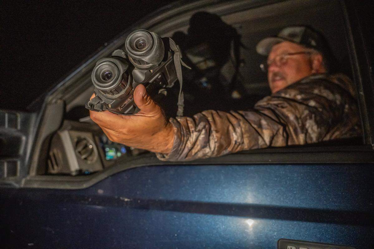 Sierra County Supervisor Paul Roen uses infrared binoculars to detect wolves in Sierra Valley on Sept. 12. Roen said the equipment is costly: “There’s a $2,500 pair of binoculars. There’s an $8,000 thermal pair of night vision binoculars. There’s a $10,000 thermal night vision drone that we have to use now to check our cows, which is rather insane.”