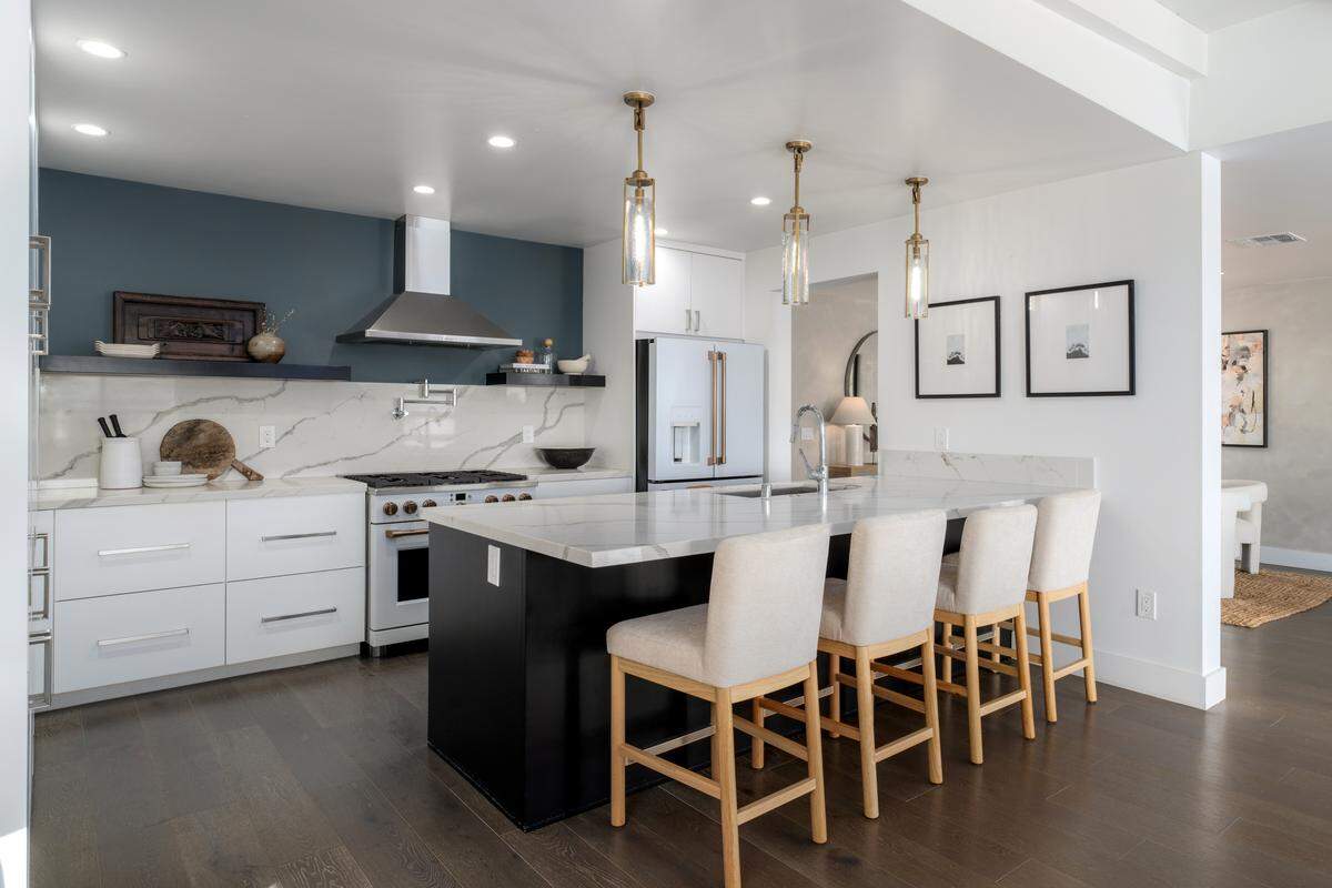 Modern details and designer touches elevate every room, from the gourmet kitchen to the luxurious primary suite in this four-bedroom, four-bath home in San Diego.