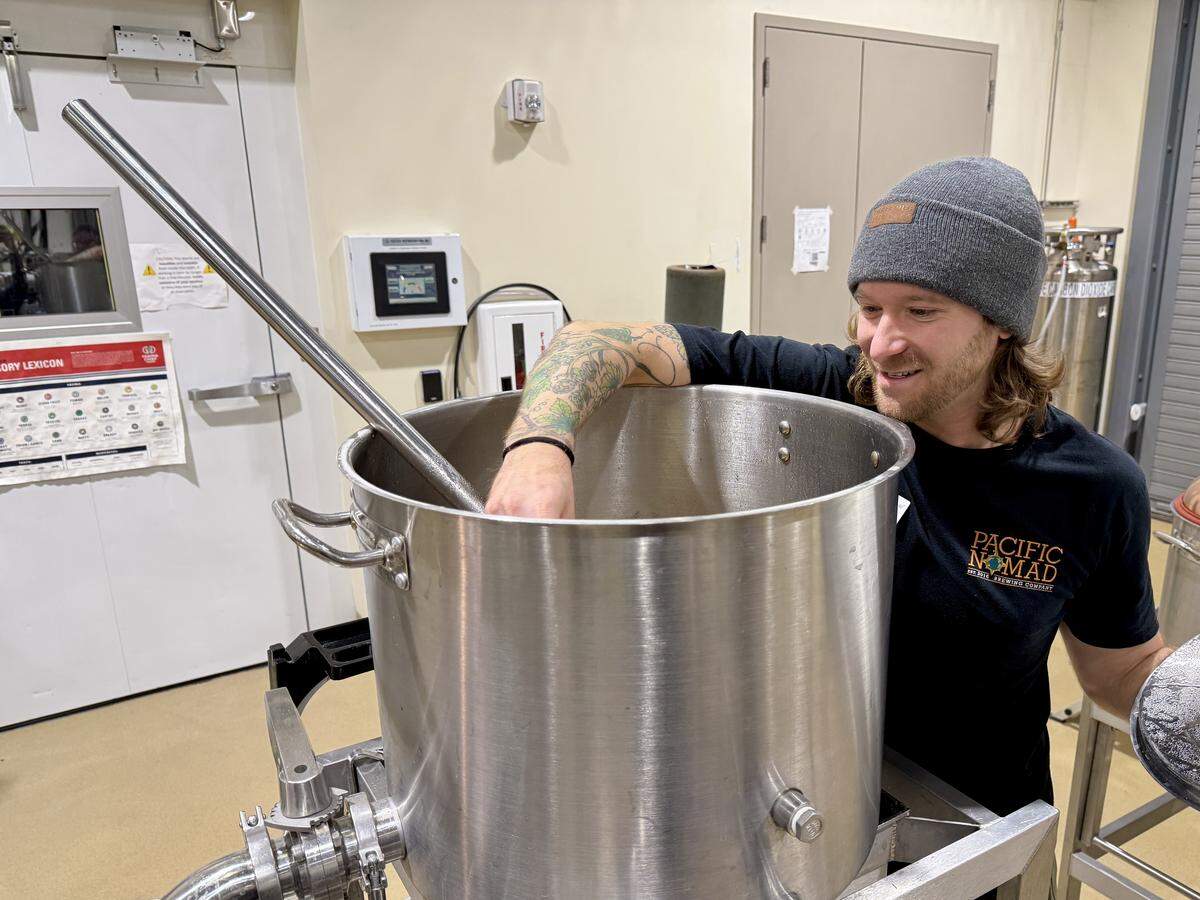 Jordan Beaver, a faculty member in the UC Davis Master Brewers Certificate Program, heats a pot of wort at the UC Davis pilot brewery on Thursday, Dec. 11, 2025. The batch uses Kernza, a perennial grain bred for sustainable agriculture.