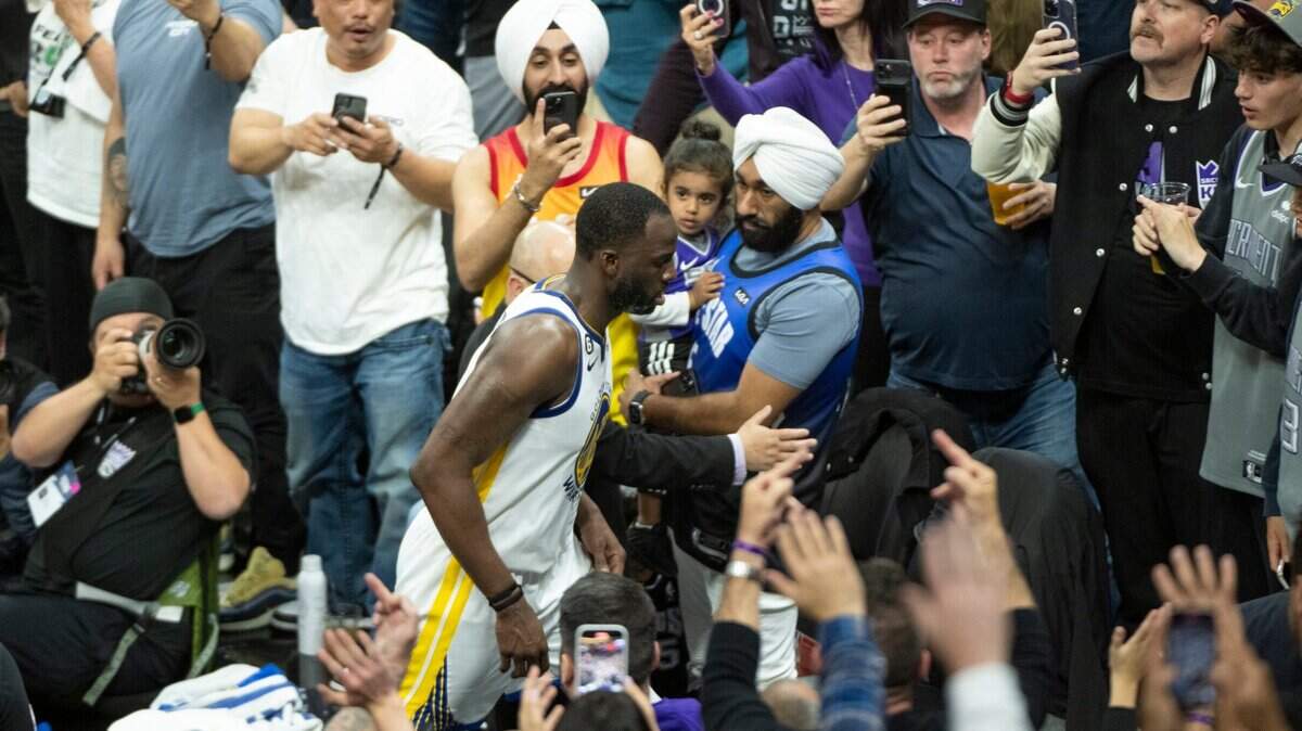 Golden State Warriors forward Draymond Green (23) walks past spectators in the fourth quarter after he was ejected for a flagrant foul against Sacramento Kings center Domantas Sabonis (10) during Game 2 of the first-round NBA playoff series at Golden 1 Center on Monday.
