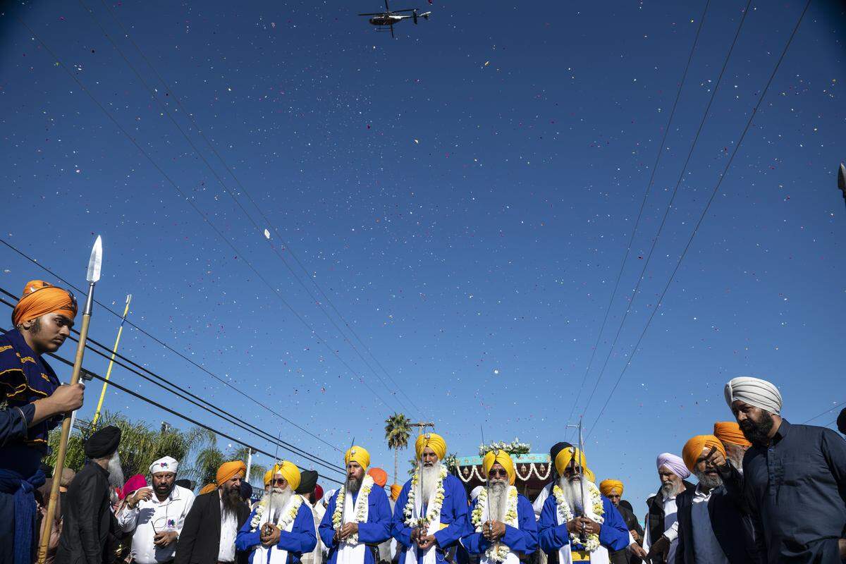 Rose petals are dropped from a helicopter before the start of Nagar Kirtan, also known as the Sikh Parade, in Sutter County on Sunday, Nov. 2, 2025.