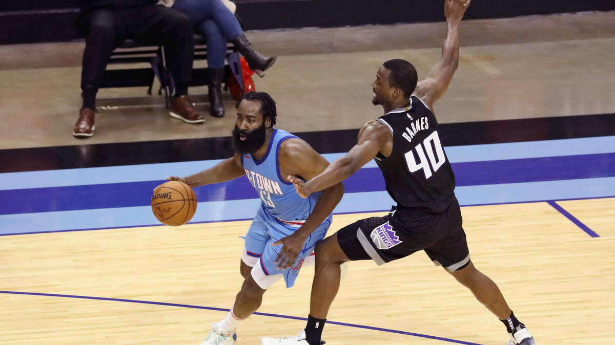 Sacramento Kings Harrison Barnes gets a hand on Houston Rockets guard James Harden during the second half of an NBA basketball game Thursday Dec. 31, 2020, in Houston.