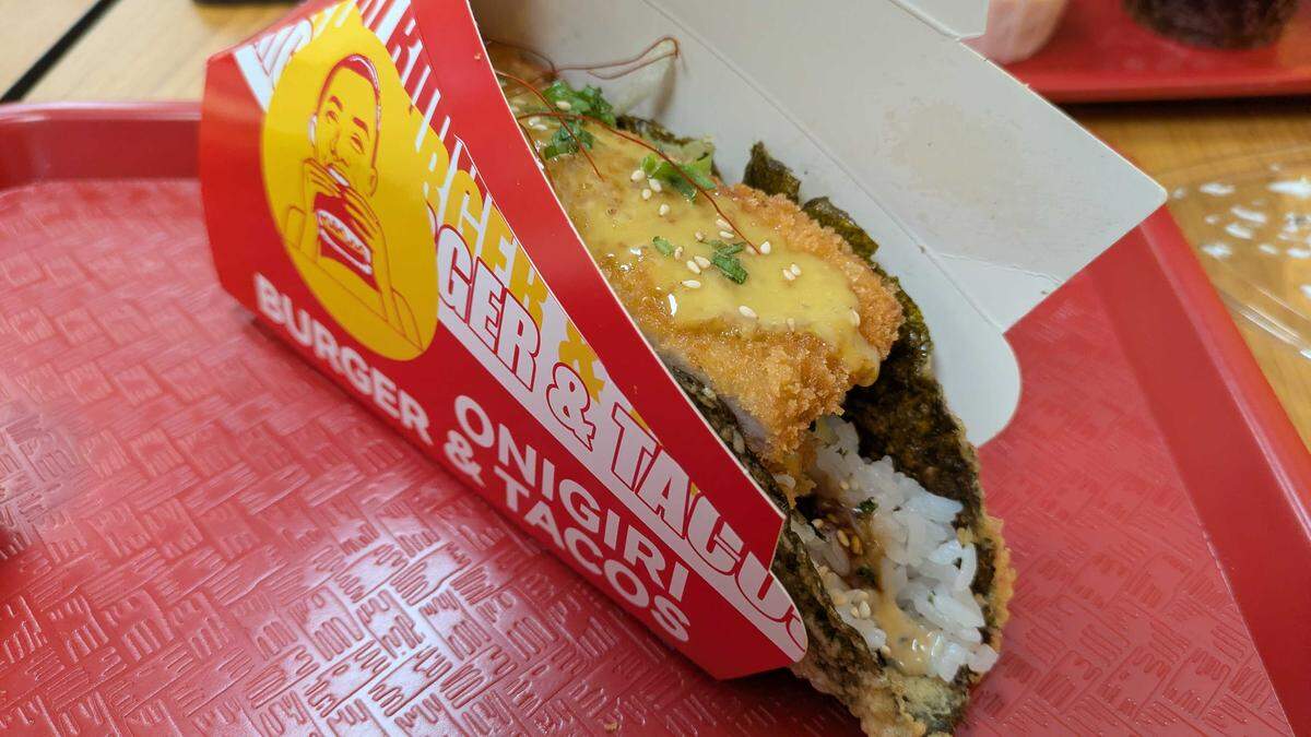The pork katsu nori at Onigiri Burgers, 4001 Freeport Blvd., Suite 110 in Sacramento, includes a crispy sheet of seaweed fried into a hard taco shell shape with rice padding its interior. Lettuce, cucumber and carrots provide a base for the fried pork chop laid over the top and drizzled with honey mustard.