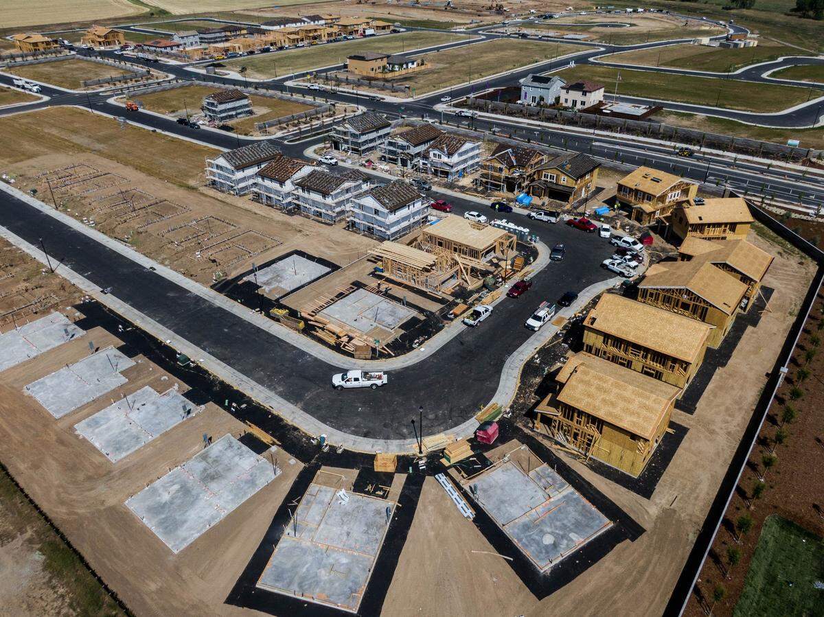 Workers build houses in the Winding Creek development in Roseville in 2021. A typical home in the city costs less than half the price of a typical one in the San Francisco Bay Area.