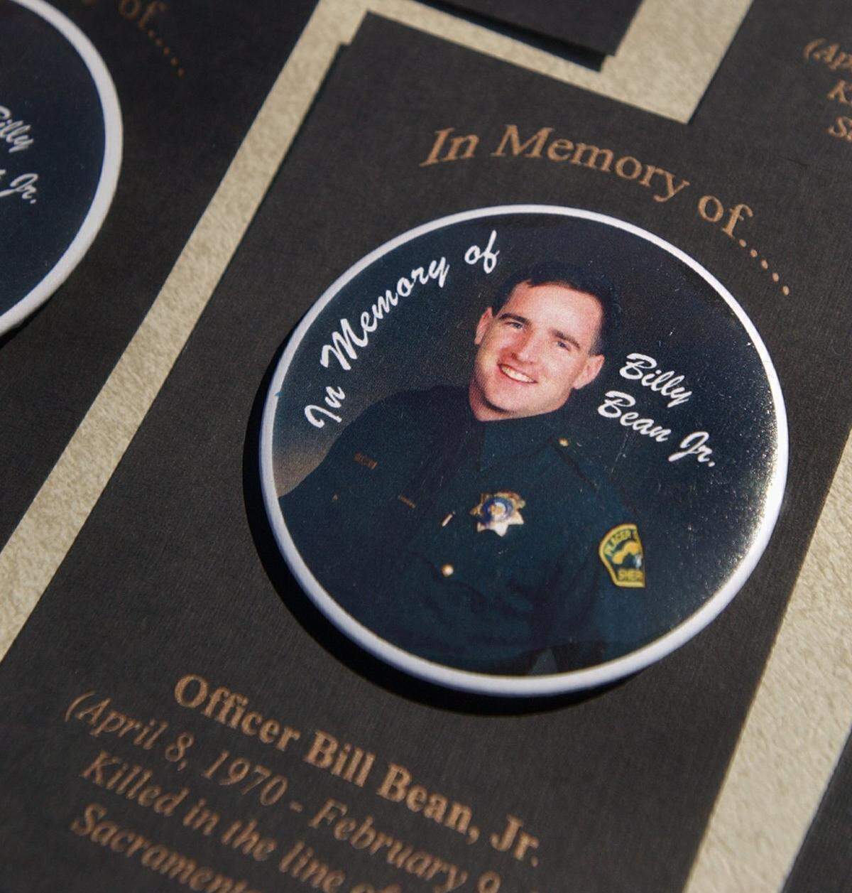 Pin-on buttons rest on a table Aug. 16, 2003, during the grand opening and dedication of Bill C. Bean Jr. Memorial Park in Colonial Manor. The Sacramento police officer was killed in the line of duty Feb. 9, 1999.