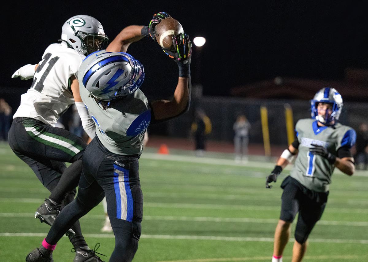 The Rocklin Thunder’s Keane Frank (12) pulls down a touchdown in the second quarter as the Granite Bay Grizzlies’ Jack Marek (21) defends on Friday.