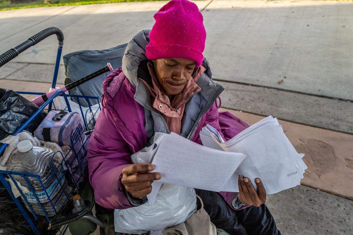 Sharon Pendarvis looks over medical paperwork in November for injuries she sustained after she says a roommate attacked her while living at Sacramento Self-Help Housing. “She came into my room and attacked me. Why was I evicted?” Pendarvis asked.