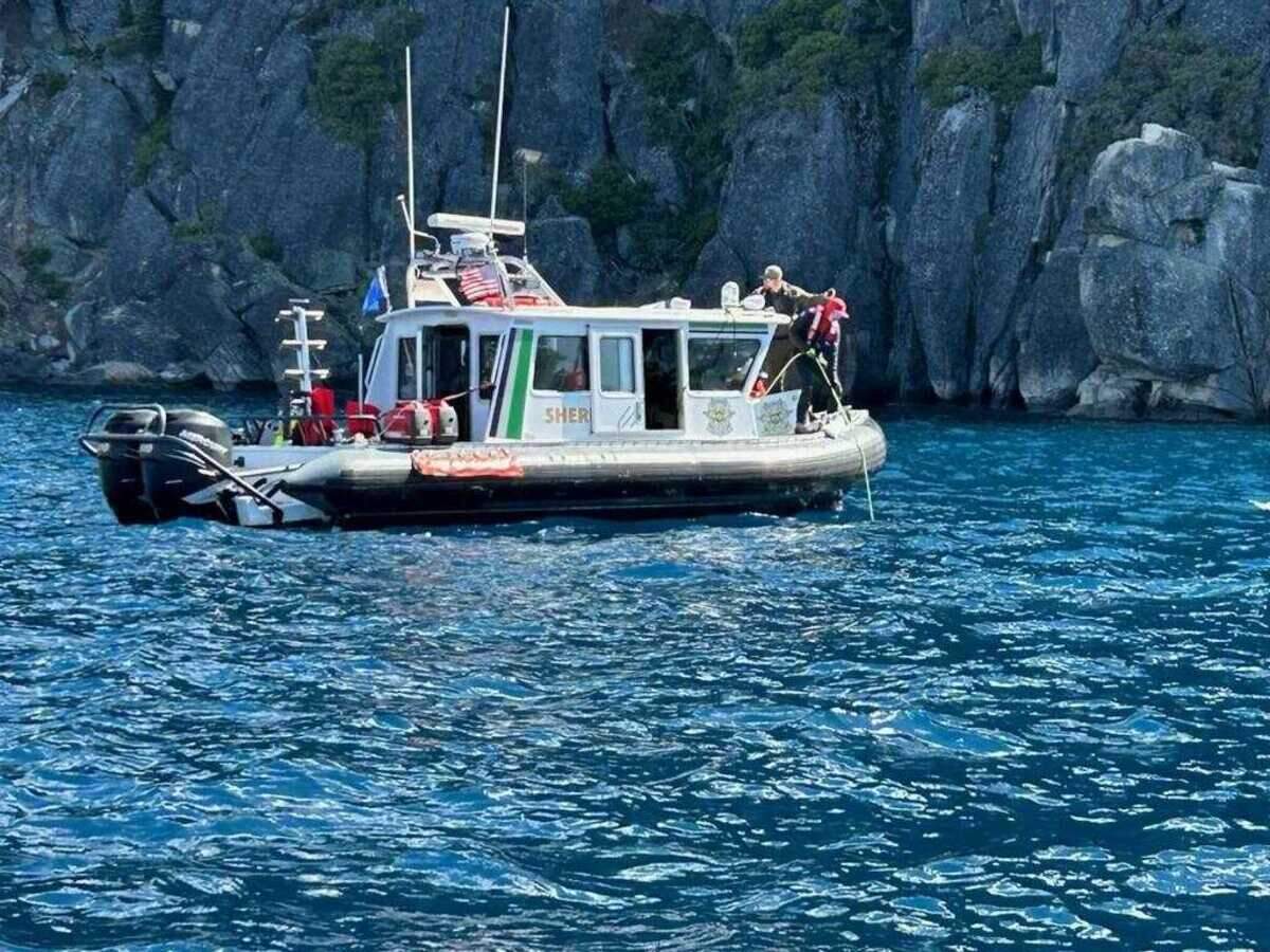 A Washoe County sheriff’s diver manages an air hose during search operations near Rubicon Point, where Lake Tahoe drops steeply to depths over 1,600 feet. Divers assisted in recovery efforts following the June 21, 2025, capsizing of a boat that killed eight people.