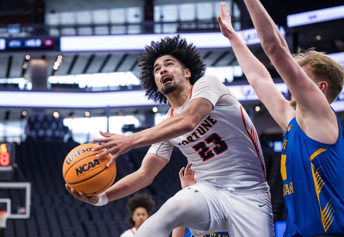Fortune Early College Panthers guard Tyree Rose (23) goes up for a shot as the Ripon Christian Knights’ Thys Van Der Hoekthe (21) defends during the Division V high school boys basketball section final Saturday.