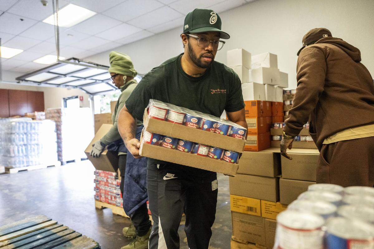 Clinton Arnold helps sort food for Thanksgiving meals at the South Sacramento Christian Center last week.