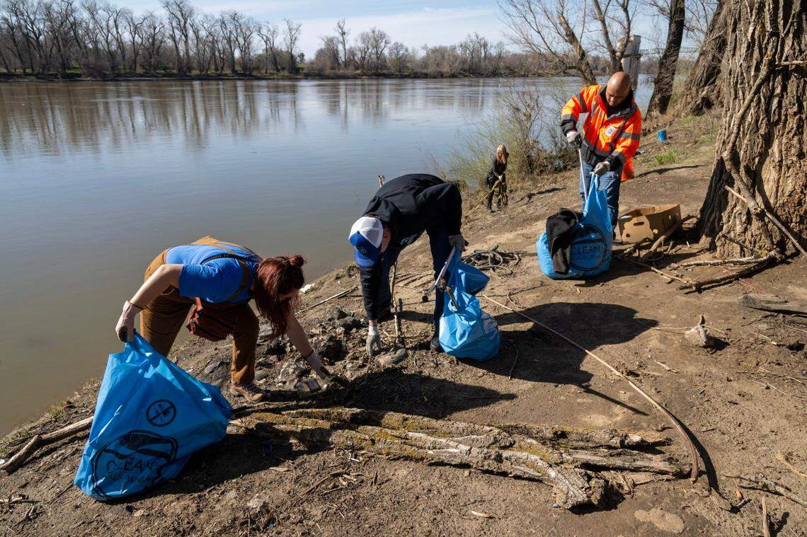 Julia Cassia, left, of the American River Parkway Foundation, helps pick up waterfront litter with other volunteers in partnership with the Sacramento Kings and Caltrans on Thursday, March 2, 2023, at Robert T. Matsui Waterfront Park on the Sacramento River. The event, part of a stormwater public education campaign, was meant to highlight how simple actions such as properly disposing of trash, picking up after pets, and regularly maintaining vehicles can have a big impact on the quality of waterways.