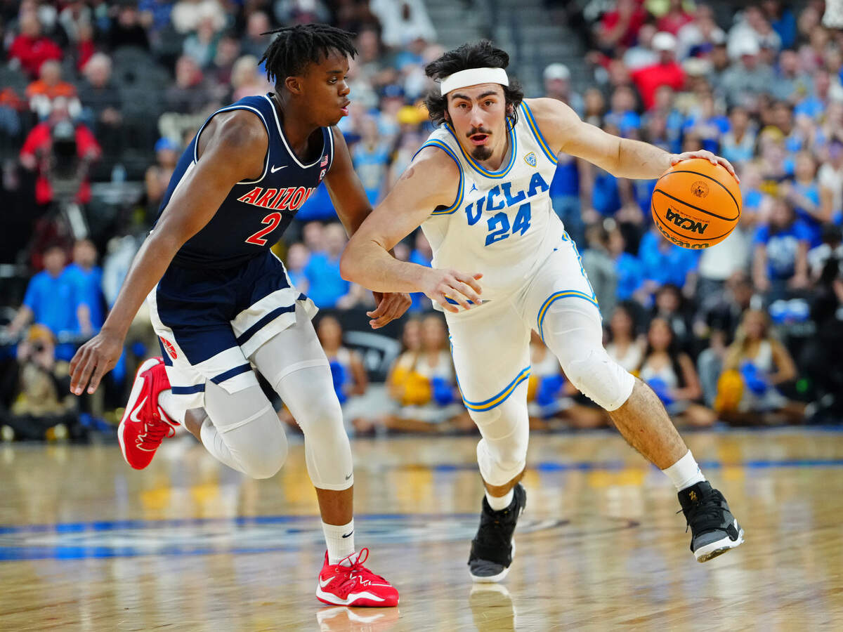 UCLA Bruins guard Jaime Jaquez Jr. (24) dribbles against Arizona Wildcats guard Adama Bal (2) at T-Mobile Arena in Las Vegas on Saturday, March 11, 2023.