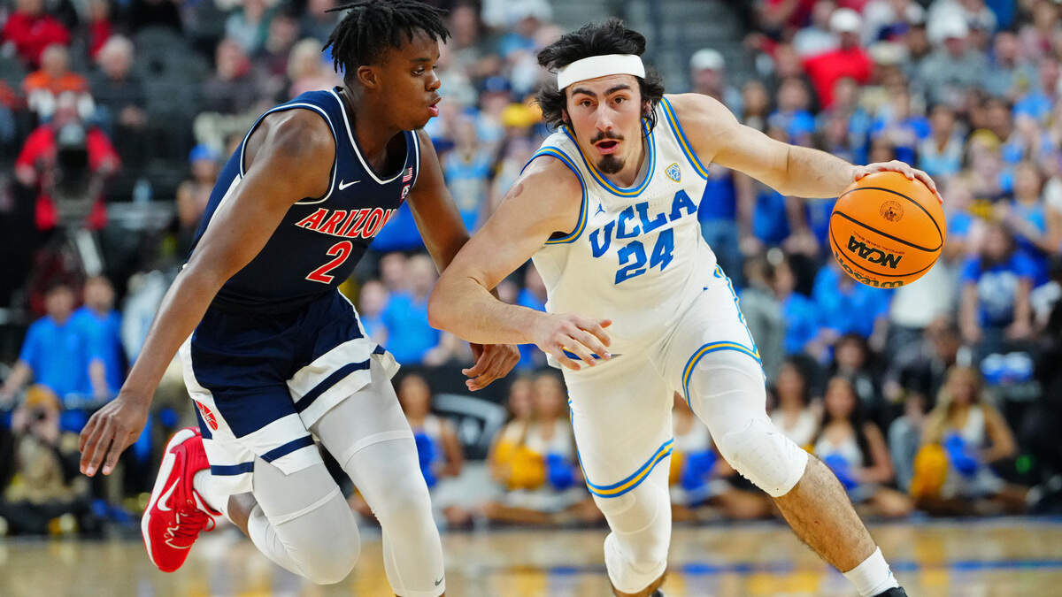 UCLA Bruins guard Jaime Jaquez Jr. (24) dribbles against Arizona Wildcats guard Adama Bal (2) at T-Mobile Arena in Las Vegas on Saturday.