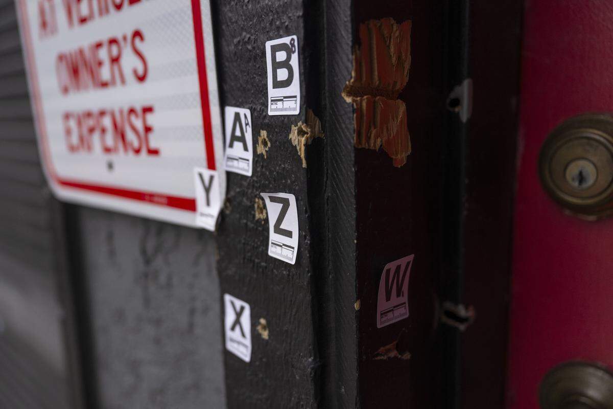 Markers identify bullet holes on Monday, Dec. 1, 2025, in the building near Stockton where 17 people were hit by gunfire in a mass shooting over the weekend.