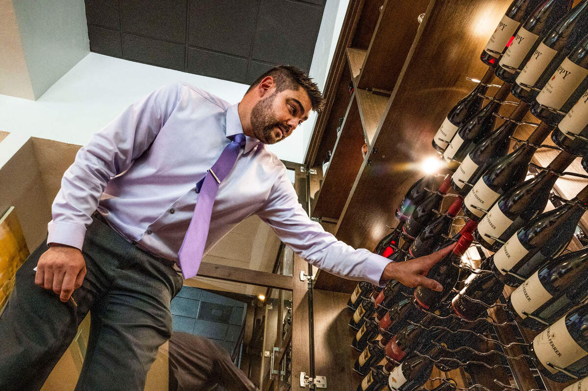 Will Cruz, general manager at Prelude Kitchen & Bar, organizes a wine case on Monday at the newly opened restaurant near the state Capitol building.