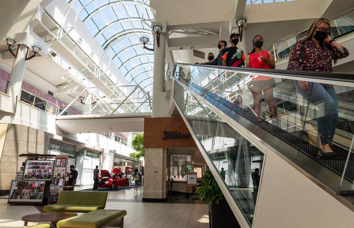 Shoppers descend the escalator at Arden Fair mail in 2021. Thefts at Bay Area and Southern California stores has Sacramento-area law enforcement preparing for Black Friday to thwart similar brazen crimes over the holiday shopping season.
