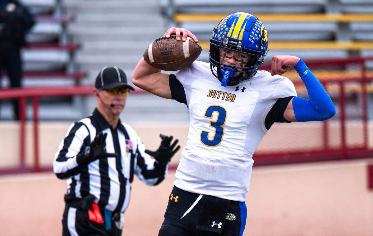 Sutter Huskies quarterback Braden Scritchfield (3) flexes in celebration after catching a touchdown pass from running back Max Bringgold on a trick play against the Casa Roble Rams in the CIF Sac-Joaquin Section Division V championship at Hughes Stadium in Sacramento on Friday.