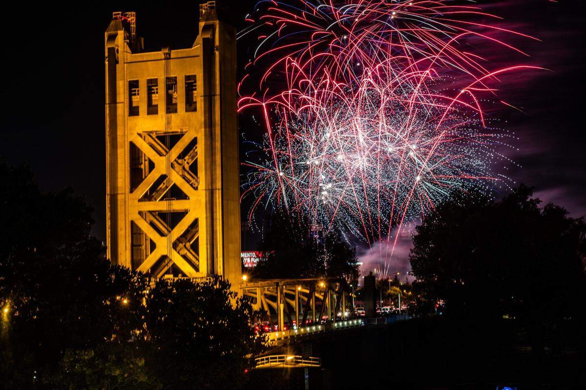 Fireworks launched from Sutter Health Park in West Sacramento explode over the Tower Bridge on Sunday, July 4, 2021.