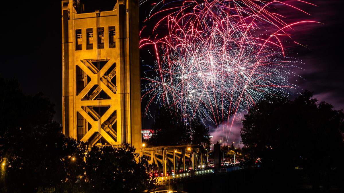 Fireworks launched from Sutter Health Park in West Sacramento explode over the Tower Bridge on Sunday, July 4, 2021.