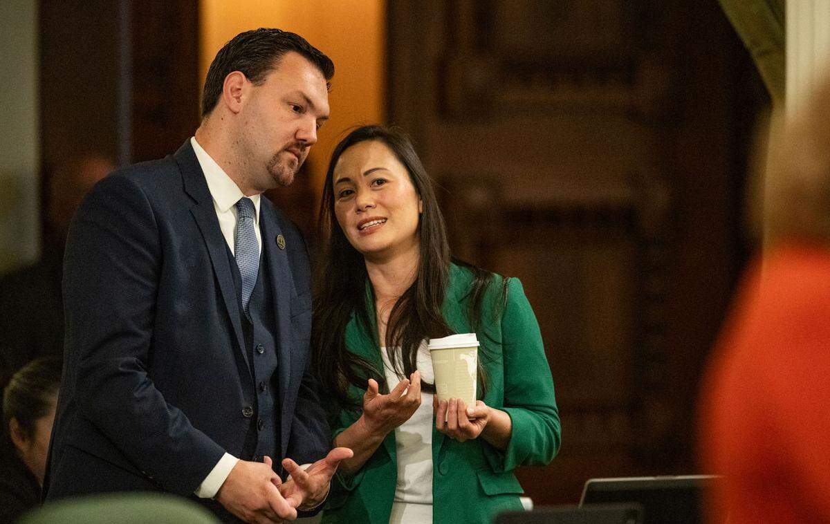 Assembly members Nick Schultz, D-Burbank, and Stephanie Nguyen, D-Elk Grove, confer during a session at the state Capitol on Thursday.