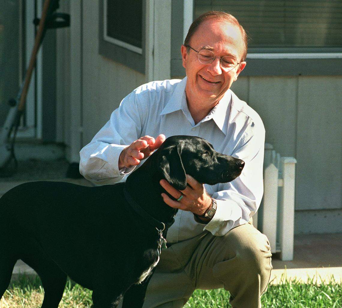 Dick Cable, former Channel 10 anchor, relaxes at home with his dog Ami in 1999.