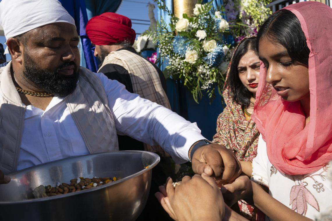 Blessings of nuts are passed out during Nagar Kirtan, also known as the Sikh Parade, in Sutter County on Sunday, Nov. 2, 2025.