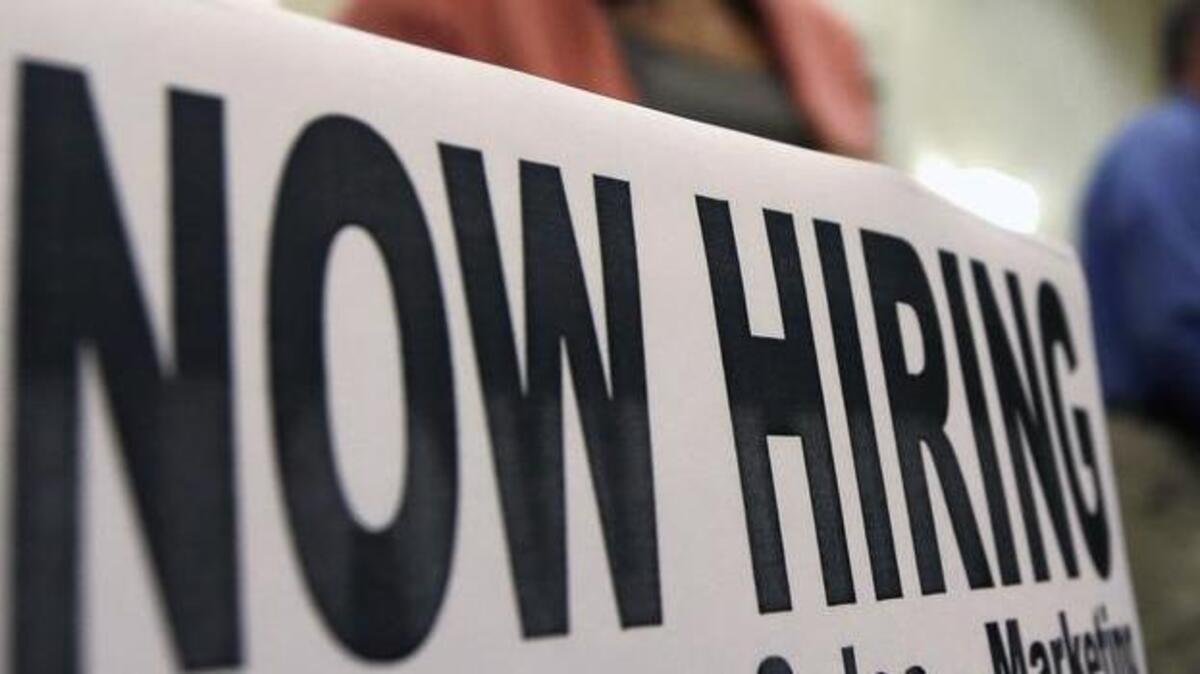 A sign attracts job-seekers during a job fair.