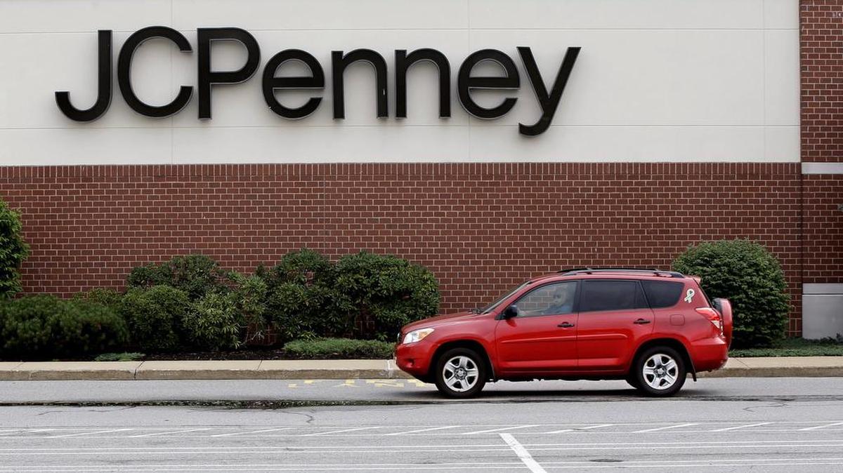 A car drives through a JCPenney department store parking lot at a mall in Hanover, Mass., on July 10, 2015.