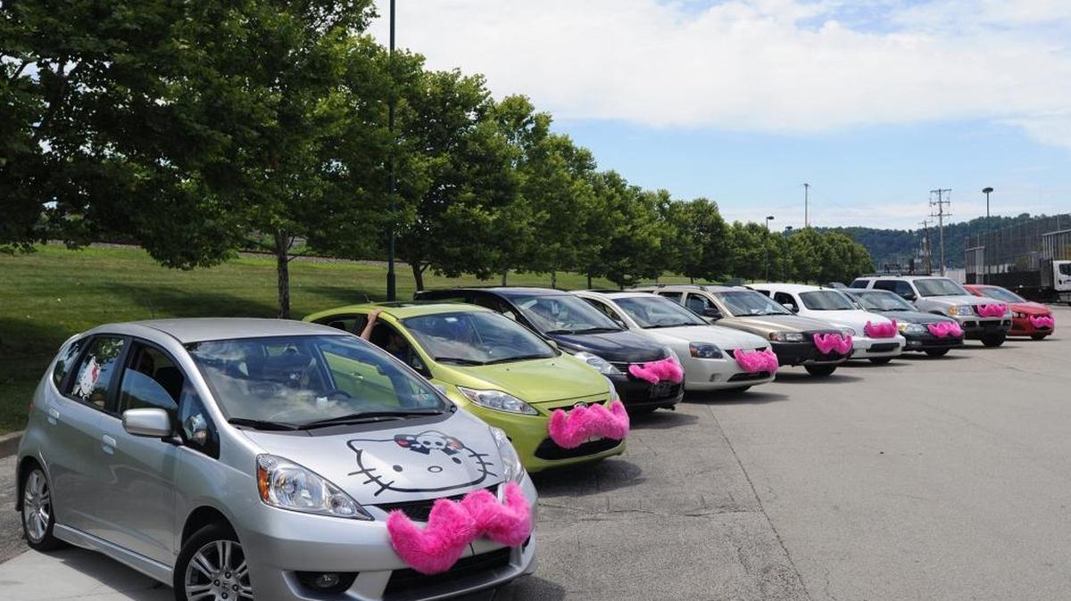 Cars for the ride-sharing firm Lyft line up in a parking lot in Homestead, Pa. New insurance options are available for California drivers working for ride-sharing companies. The insurers say their products help fill insurance gaps for policyholders driving for firms like Lyft and Uber, both headquartered in San Francisco.