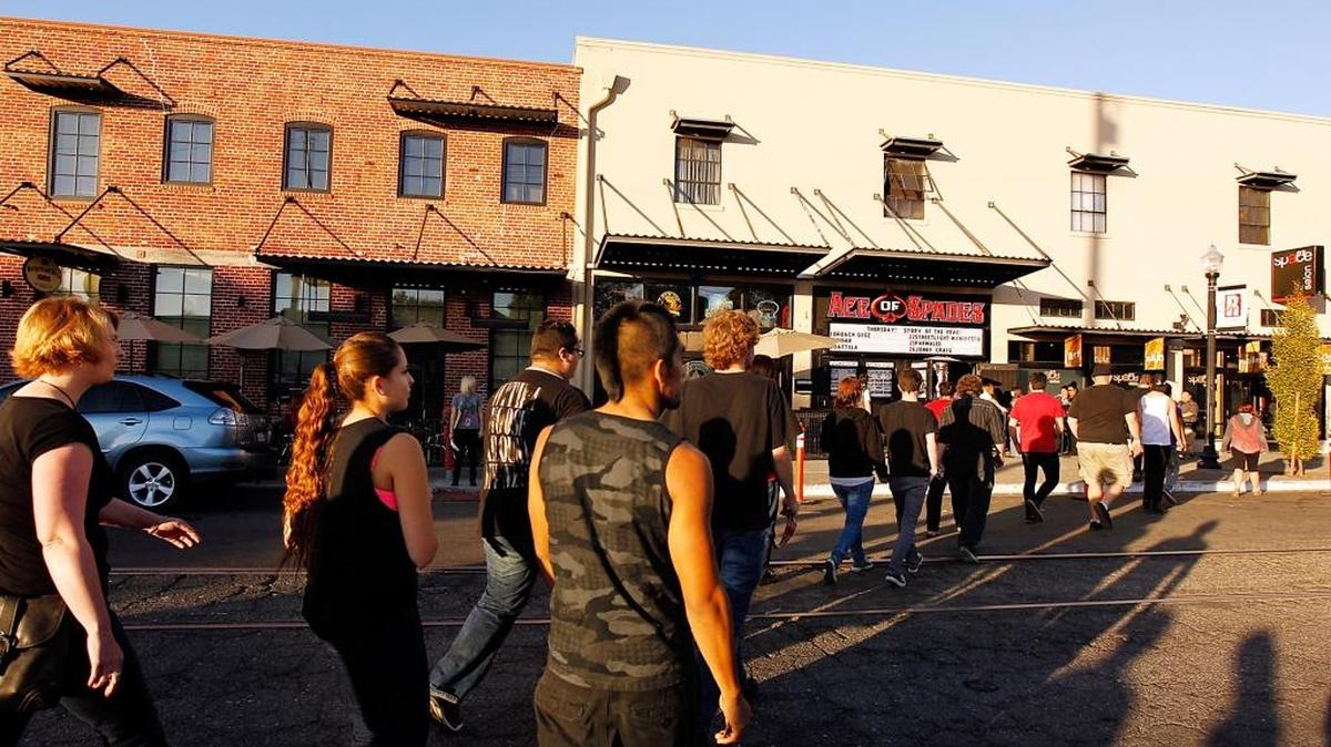 Concert-goers cross R Street as the doors open at the Ace of Spades music venue in October 2013. Fans line up across the street for hours before the nightclub opens.