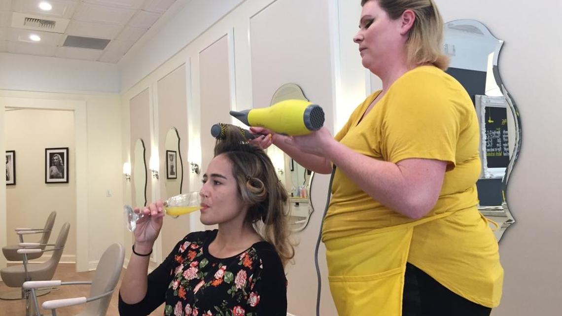 Jenn Kistler-McCoy sips a mimosa as she has her hair styled at the new Sacramento Drybar location. Launched in 2010, the fast-growing chain opened its first Sacramento location on Sept. 22.