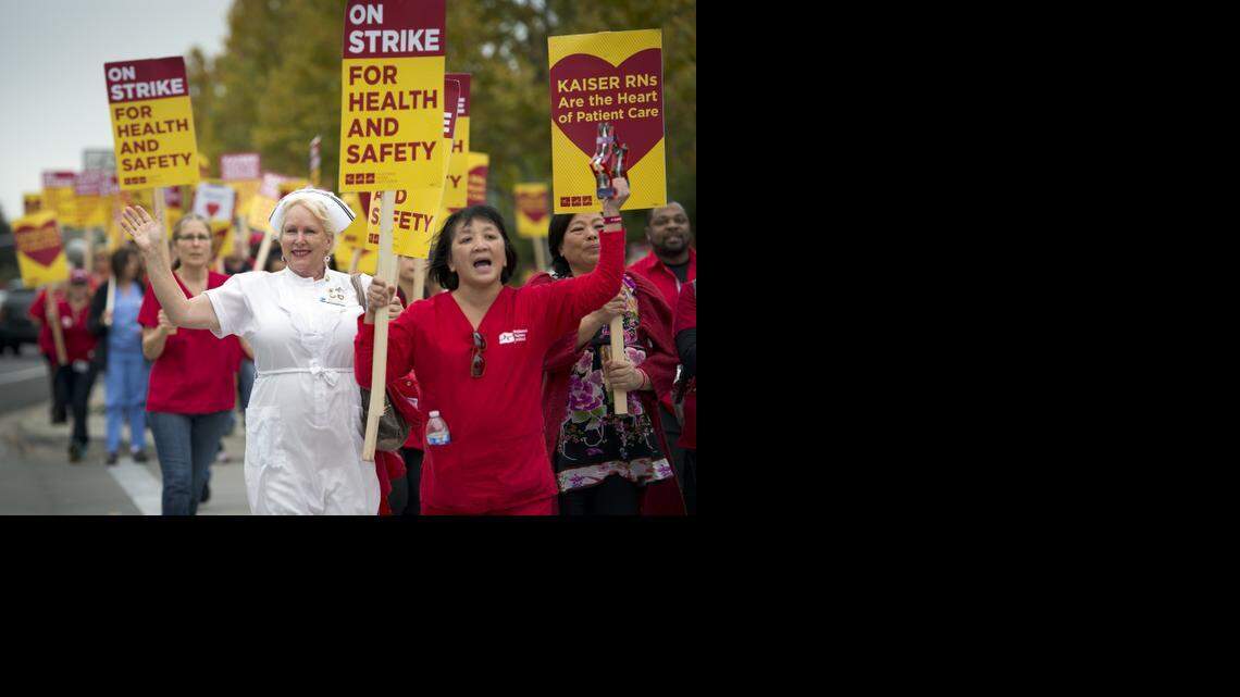 
Wendy Fischer, left, who has been a Kaiser nurse for nearly 35 years, walks with other striking Kaiser nurses around the perimeter of Kaiser Permanente Medical Center, Roseville, on Tuesday in Roseville.
