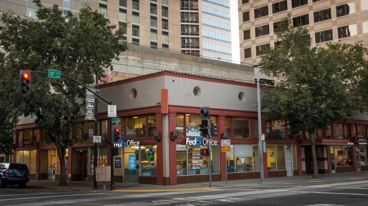 
A busy FedEx store fronts the century-old building that was sold on Thursday.

