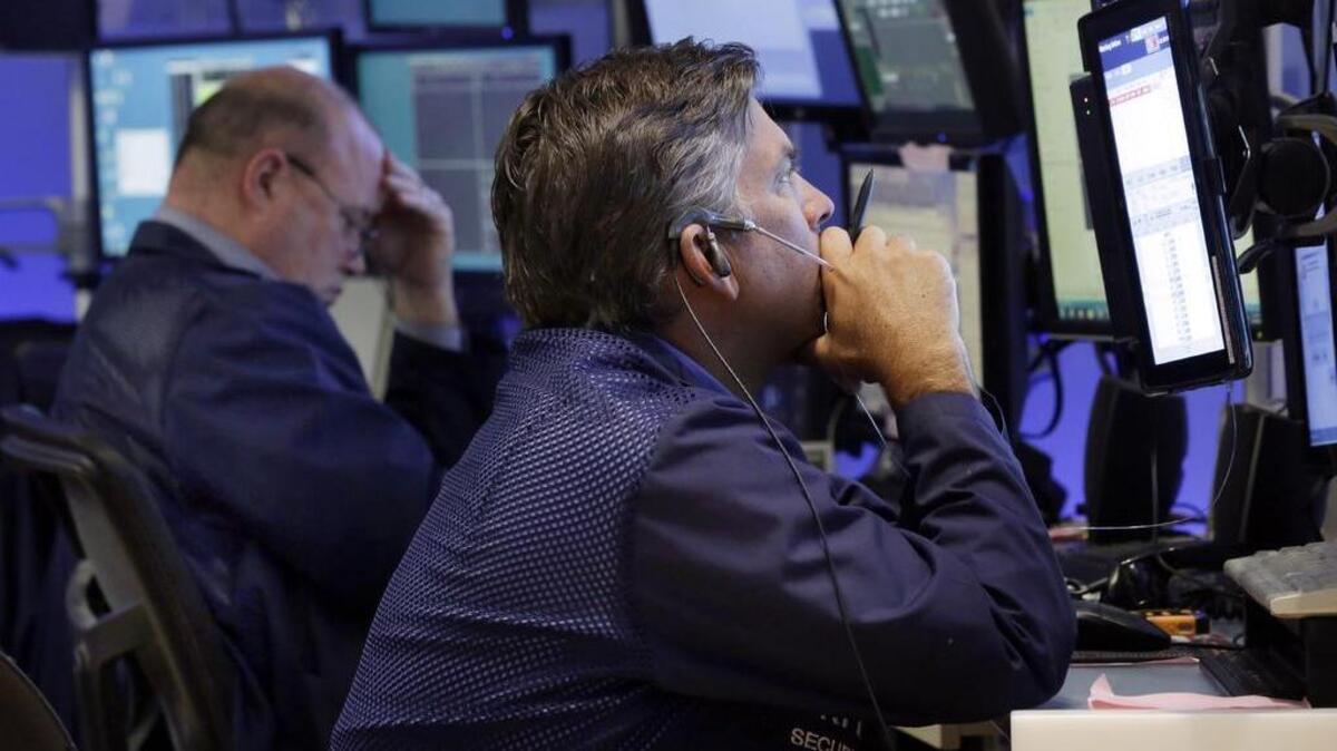 
Traders work in a booth on the floor of the New York Stock Exchange, Monday.
