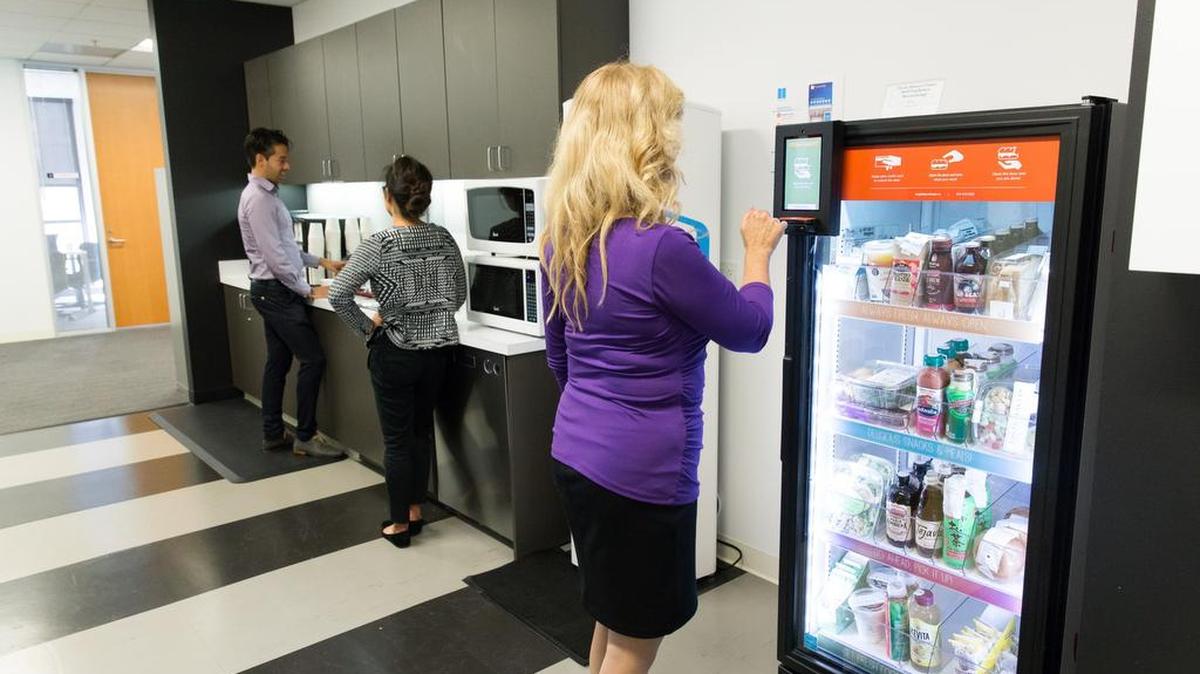 An office worker swipes a credit or debit card at a smart refrigerator produced by San Rafael-based Byte Foods. The 18-month-old company plans to launch its units at Sacramento-area businesses in April.