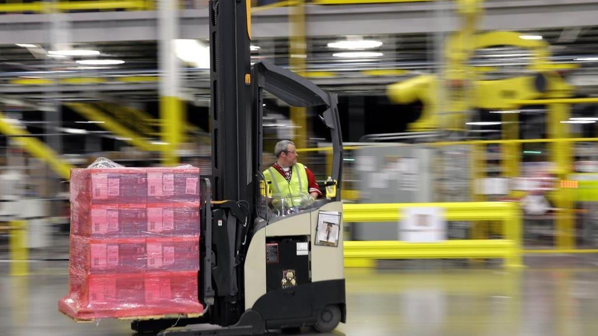 A forklift driver moves a pallet of goods through an Amazon.com distribution center in 2015 in DuPont, Wash. A center under construction near Sacramento International Airport plans to hire 1,500 full-time workers, a 50 percent increase over earlier plans.