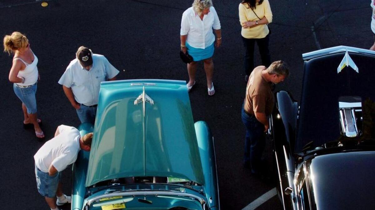 Spectators look at classic cars during Roseville’s Downtown Tuesday Nights festival, May 6, 2008.