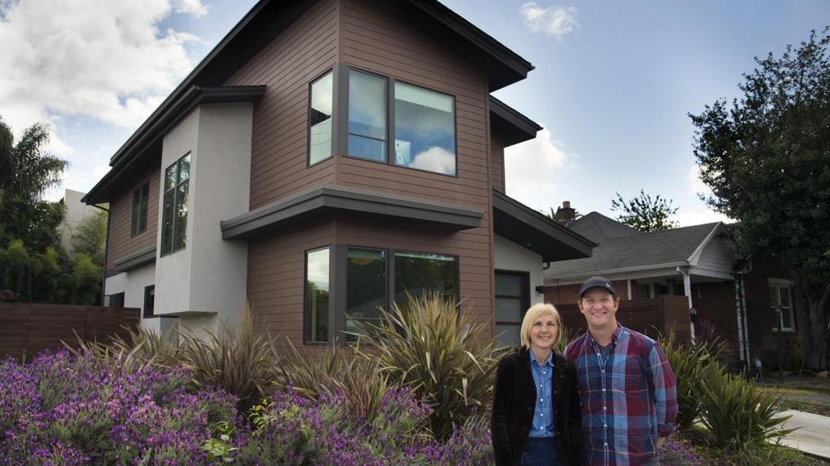Erica and Nathan Cunningham, owners of Indie Capital, stand outside a home they built near 20th and Broadway on Monday in Sacramento. Their focus has been on infill projects and, over the years, they have quietly had an impact on improving neighborhoods by building appealing modern houses on vacant lots in challenging areas.