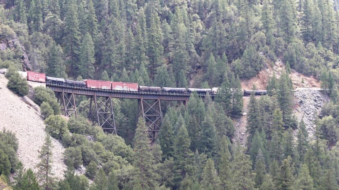 A BNSF train carrying dozens of tank cars crosses an 80-year-old trestle heading south to Union Pacific Railroad tracks through the Feather River Canyon.
