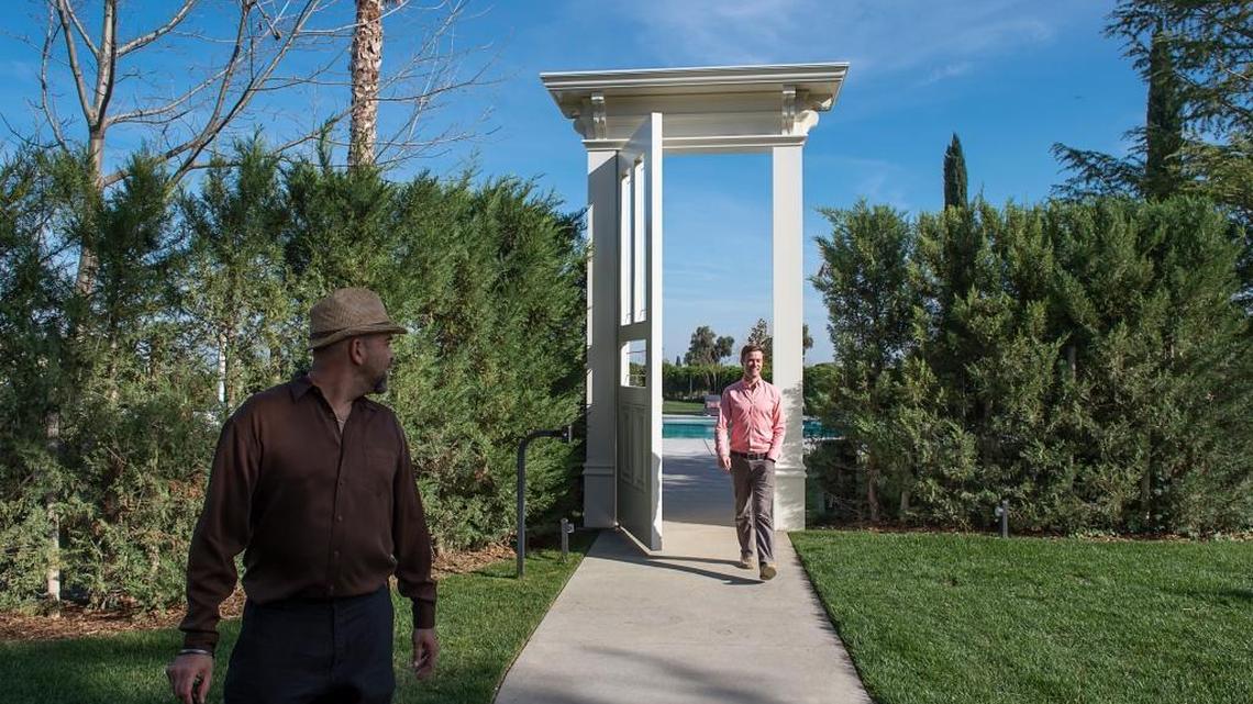 Inn at Park Winters owners Rafael Galiano, left, and John Martin walk from the pool at their inn in Winters in February. The Inn at Park Winters is a large Victorian, on 10 acres outside Winters in Yolo County. It recently started serving dinner.