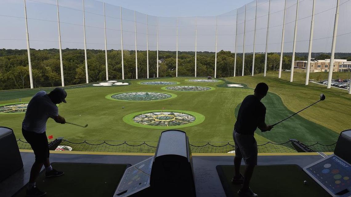 Two golfers play the "course" at Topgolf in Overland Park, Thursday, Aug. 27, 2015.