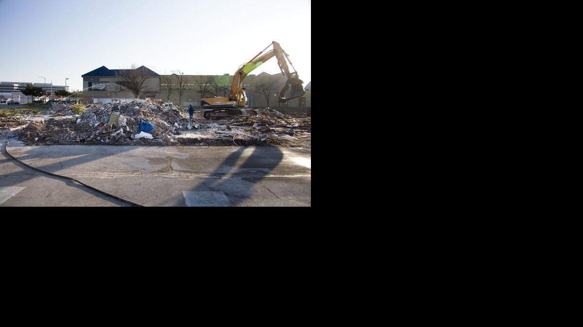 
Workers sort through debris at the former Motel 6 Friday - site of the recent fatal shooting of a Sacramento county deputy - which is being leveled to make way for a new shopping complex.
