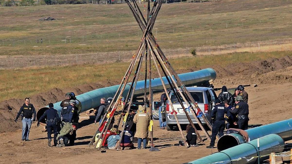 In October, law officers remove a person protesting the Dakota Access pipeline near the town of St. Anthony, N.D. The Davis City Council voted late Tuesday to sever ties with Wells Fargo after residents voiced concerns about the company’s involvement in the controversial pipeline.