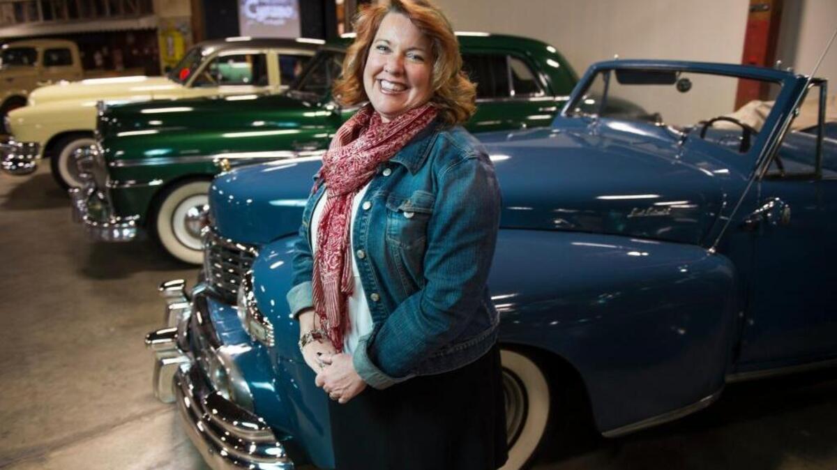 Karen McClaflin, executive director of the California Automobile Museum, is photographed with some of the cars on exhibit in March.