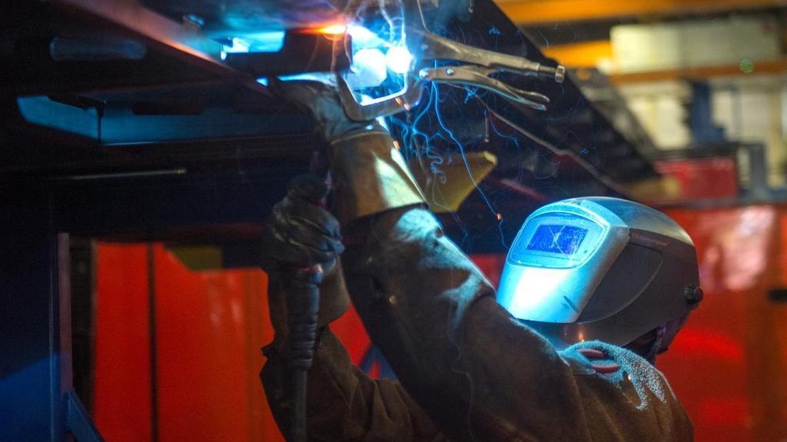 Siemens employee Anzio Taylor welds the roof section of a light-rail car at the south Sacramento plant in October 2015. Siemens just obtained a major contract with San Diego’s mass transit system.