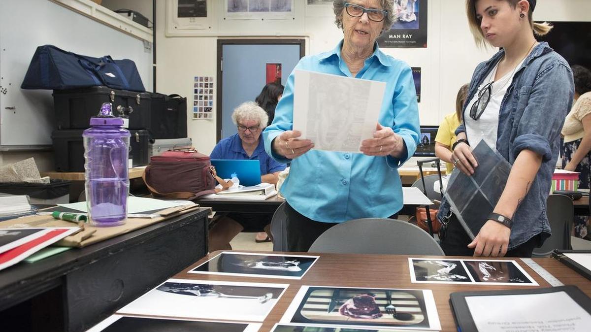 Rebecca Gregg, 73, who has been a counselor and photography teacher at Sierra College for 48 years, looks over photographs taken by student Courtney McArthur, who is putting together her final portfolio. Gregg is retiring at the end of the semester.