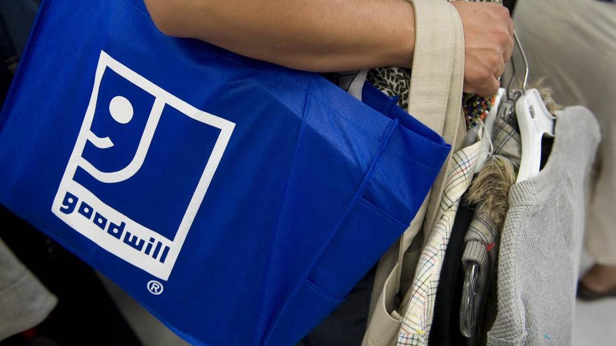A shopper waits in line to pay for her merchandise during the grand opening of a Goodwill store in south Sacramento.